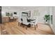 Elegant dining area with hardwood floors, modern lighting, and views into a modern kitchen at 2433 Helmsdale Ne Dr, Atlanta, GA 30345