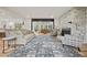 Bright living room featuring hardwood floors, stylish furniture, and a decorative brick fireplace at 2433 Helmsdale Ne Dr, Atlanta, GA 30345