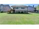 Large backyard featuring a well-manicured lawn, deck, and the rear of the house at 5320 Northview Lk, Cumming, GA 30040