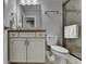 Cozy bathroom featuring granite countertops, a large mirror, and tiled shower at 5320 Northview Lk, Cumming, GA 30040