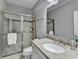 Bathroom showcasing a granite countertop, glass shower doors, and modern fixtures at 5320 Northview Lk, Cumming, GA 30040