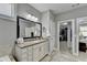 Bright bathroom featuring a granite countertop, large mirror, and a walk-in closet at 5320 Northview Lk, Cumming, GA 30040