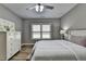 Comfortable bedroom featuring natural light, a ceiling fan, and neutral wall colors at 5320 Northview Lk, Cumming, GA 30040