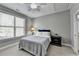 Comfortable bedroom with a ceiling fan, neutral walls, and a bright window at 5320 Northview Lk, Cumming, GA 30040