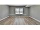 Bright bedroom with a large window that provides plenty of natural light and modern flooring at 5320 Northview Lk, Cumming, GA 30040