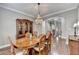 Spacious dining room with hardwood floors, elegant lighting, and connections to other rooms at 5320 Northview Lk, Cumming, GA 30040