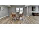 Bright dining area featuring a wooden table set with chairs and large window that provides natural light at 5320 Northview Lk, Cumming, GA 30040