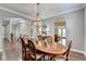 Hardwood dining room with dark stained floors and views into the kitchen at 5320 Northview Lk, Cumming, GA 30040