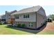 Rear view of the home with a deck, back patio and brick and siding exterior showcasing a well-manicured lawn at 5320 Northview Lk, Cumming, GA 30040