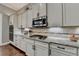 A gourmet kitchen features granite countertops and modern stainless steel appliances at 5320 Northview Lk, Cumming, GA 30040