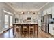 Spacious open kitchen features a center island with seating and stainless steel appliances at 5320 Northview Lk, Cumming, GA 30040