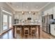 A spacious open kitchen features a center island with seating and stainless steel appliances at 5320 Northview Lk, Cumming, GA 30040