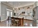 A spacious open kitchen features a center island with seating and stainless steel appliances at 5320 Northview Lk, Cumming, GA 30040