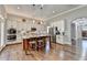 Open kitchen with island and seating, modern appliances, hardwood floors at 5320 Northview Lk, Cumming, GA 30040