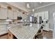 Spacious kitchen featuring an island, granite countertops, modern stainless steel appliances, and pendant lighting at 5320 Northview Lk, Cumming, GA 30040
