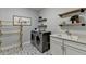 Well-organized laundry room with modern appliances, shelving, shiplap paneling and stylish flooring at 5320 Northview Lk, Cumming, GA 30040