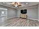 Bright living area with recessed lighting, ceiling fan, and a flat-screen TV, creating an inviting atmosphere at 5320 Northview Lk, Cumming, GA 30040