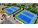 Aerial view of tennis courts with blue surface and green surroundings, perfect for recreation at 5320 Northview Lk, Cumming, GA 30040