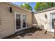 Cozy outdoor deck features French doors, lighting and outdoor dining table and chairs at 1010 Eden Se Ave, Atlanta, GA 30316