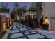 Backyard patio with stone pavers, wooden deck with stairs, and ambient lighting, ideal for entertaining at 1010 Eden Se Ave, Atlanta, GA 30316