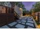 Well-lit backyard featuring a patio, wooden deck with stairs, and a detached garage with stone and gravel accents at 1010 Eden Se Ave, Atlanta, GA 30316