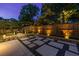 Backyard stone paver patio with ambient lighting, perfect for relaxing and entertaining at twilight at 1010 Eden Se Ave, Atlanta, GA 30316