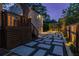 Backyard featuring a stone paver patio, wooden deck with railings, and a fenced yard at dusk at 1010 Eden Se Ave, Atlanta, GA 30316