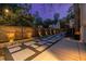 Backyard patio with paver stones, ambient lighting, and a wooden fence, perfect for outdoor gatherings at 1010 Eden Se Ave, Atlanta, GA 30316