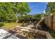 Landscaped backyard with stone seating area, fire pit and lush plantings and grass at 1010 Eden Se Ave, Atlanta, GA 30316