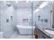 Bright and luxurious bathroom with walk-in shower, soaking tub, and white marble tile at 1010 Eden Se Ave, Atlanta, GA 30316