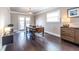 Elegant dining room featuring a wooden table, bench seating, and ample natural light from the adjacent doors at 1010 Eden Se Ave, Atlanta, GA 30316