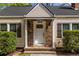 Detailed view of the front entryway with stone accents and a well-maintained hedge at 1010 Eden Se Ave, Atlanta, GA 30316