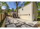 View of the home's back exterior with stone paver driveway, large garage and backyard access at 1010 Eden Se Ave, Atlanta, GA 30316