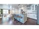 Open-concept kitchen with a large central island, bar stool seating, and modern stainless-steel appliances at 1010 Eden Se Ave, Atlanta, GA 30316