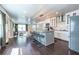 Bright, modern kitchen with a large island, bar stools, and a view of the living area and front entrance at 1010 Eden Se Ave, Atlanta, GA 30316