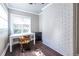 Bright office space featuring a work desk, natural light from the window, and stylish painted brick wall at 1010 Eden Se Ave, Atlanta, GA 30316
