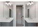 Well-lit bathroom with double vanity and framed mirrors with access to a tub-shower combination at 1911 Commons Cir, Brookhaven, GA 30341