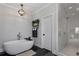 Modern bathroom with a soaking tub and glass-enclosed shower at 1911 Commons Cir, Brookhaven, GA 30341