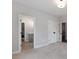 A carpeted bedroom provides entry to a bathroom and closet, featuring neutral paint and recessed lighting at 1911 Commons Cir, Brookhaven, GA 30341
