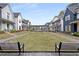 A scenic view of the community featuring homes with inviting walkways, benches, and manicured lawns at 1911 Commons Cir, Brookhaven, GA 30341