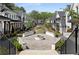 View of community fire pit surrounded by meticulously landscaped yards, walkways, and charming homes at 1911 Commons Cir, Brookhaven, GA 30341