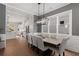 Dining room with modern lighting, large windows, and an adjacent kitchen area at 1911 Commons Cir, Brookhaven, GA 30341