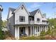 Stylish two-story home featuring gray and white siding with a cozy front porch and balcony at 1911 Commons Cir, Brookhaven, GA 30341