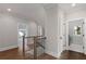 Bright hallway with hardwood floors, leading to the laundry room and a bedroom at 1911 Commons Cir, Brookhaven, GA 30341