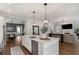 Open-concept kitchen with island, stainless steel appliances, and views of the dining and living areas at 1911 Commons Cir, Brookhaven, GA 30341