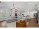 Open-concept living space with a comfortable sofa and seamless access to a modern kitchen at 1911 Commons Cir, Brookhaven, GA 30341