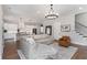 Bright and spacious living room with hardwood floors and an open layout connecting to the kitchen at 1911 Commons Cir, Brookhaven, GA 30341