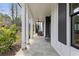 Relaxing covered porch, showcasing a charming outdoor space with stone flooring and seating at 1911 Commons Cir, Brookhaven, GA 30341
