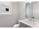 Powder room with modern vanity, quartz countertop, and a view of the window at 1911 Commons Cir, Brookhaven, GA 30341