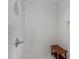Close-up of a white-tiled shower with a wooden bench at 1911 Commons Cir, Brookhaven, GA 30341